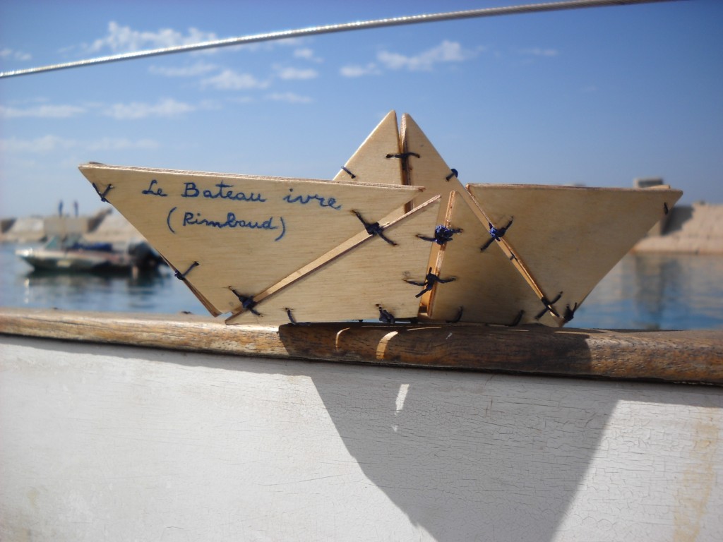 Le bateau ivre, a wood mobile composed by several pieces attached together to make a small hanging boat. Inspired by the verse-poem Le Bateau ivre