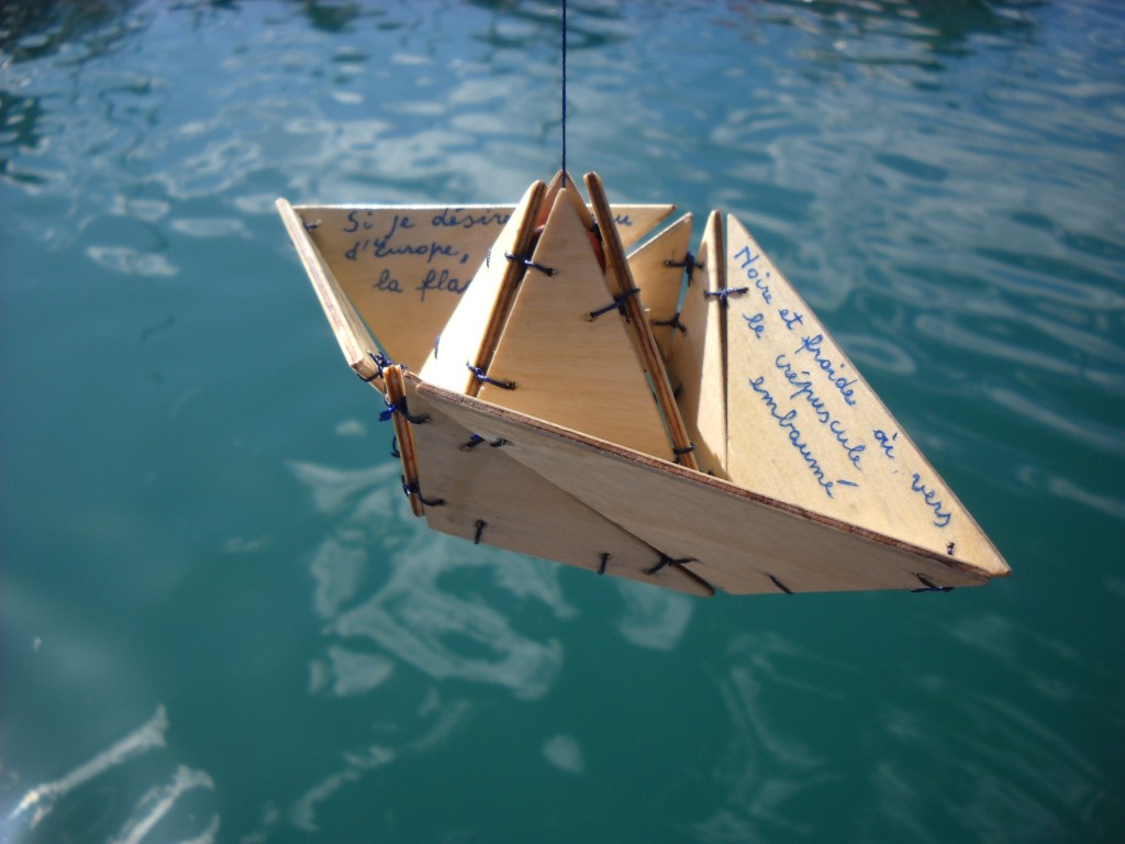 Le bateau ivre, a wood mobile composed by several pieces attached together to make a small hanging boat. Inspired by the verse-poem Le Bateau ivre