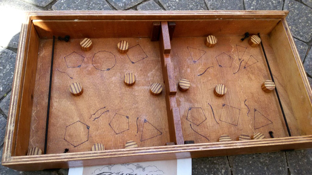 Wood table game box with inside rubber bands to shoot small circles